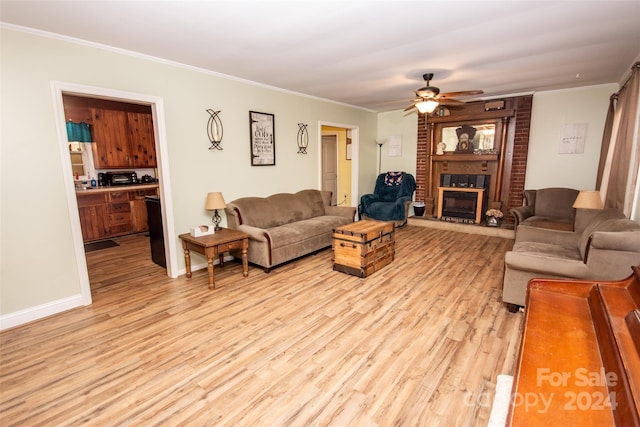 living room featuring light wood-type flooring, ceiling fan, and crown molding