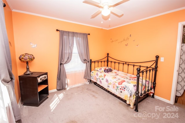 carpeted bedroom featuring ceiling fan and crown molding