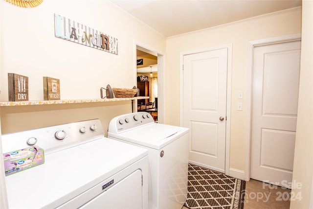 laundry room with washer and clothes dryer and ornamental molding