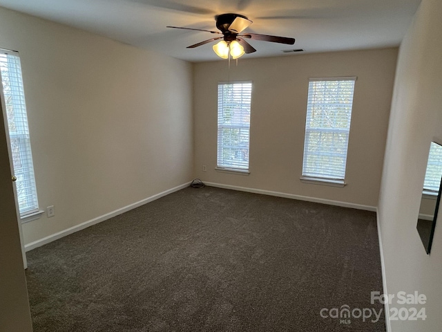 carpeted empty room featuring ceiling fan