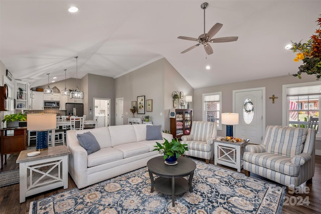 living room featuring lofted ceiling, dark wood-type flooring, crown molding, and ceiling fan