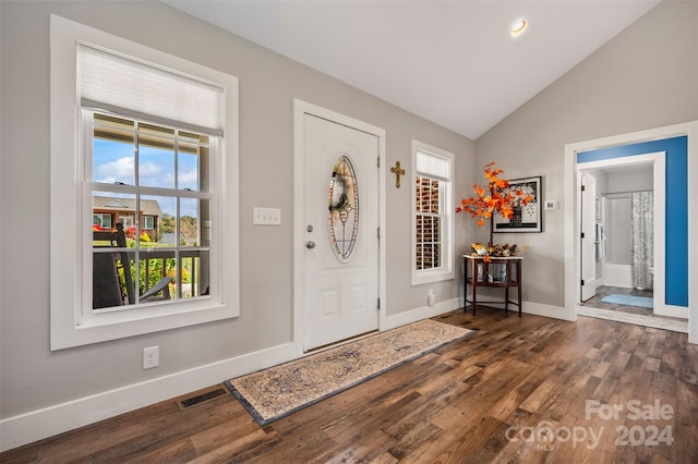 foyer entrance with vaulted ceiling and dark hardwood / wood-style flooring