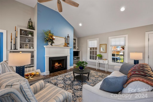 living room featuring ceiling fan, hardwood / wood-style flooring, and vaulted ceiling