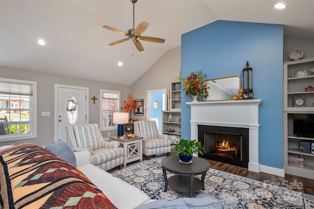 living room with ceiling fan, lofted ceiling, and dark hardwood / wood-style floors