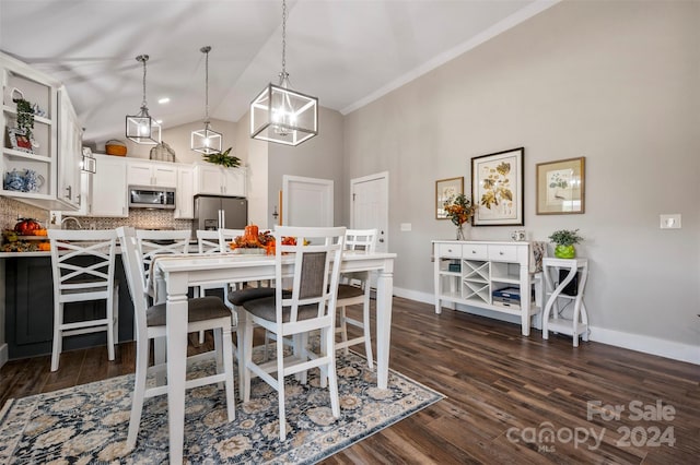 dining area with a notable chandelier, high vaulted ceiling, and dark hardwood / wood-style flooring