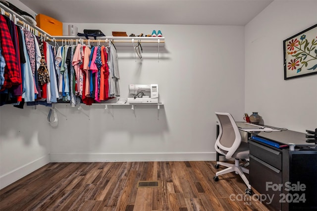 spacious closet featuring dark wood-type flooring