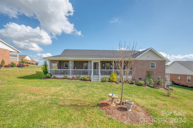 rear view of property with a yard and covered porch