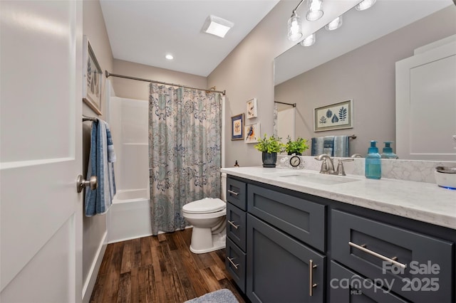128 Augusta Dr, Spindale, NC 28160 - bathroom featuring toilet, vanity, shower / tub combo with curtain, and wood finished floors