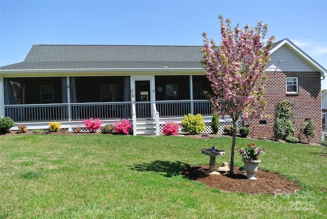 128 Augusta Dr, Spindale, NC 28160 - view of front of house with brick siding, a sunroom, and a front lawn