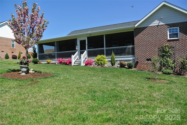 128 Augusta Dr, Spindale, NC 28160 - back of property featuring a lawn and a sunroom