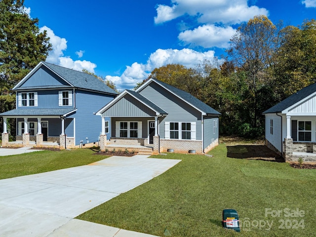 craftsman inspired home featuring covered porch, a front yard, and crawl space