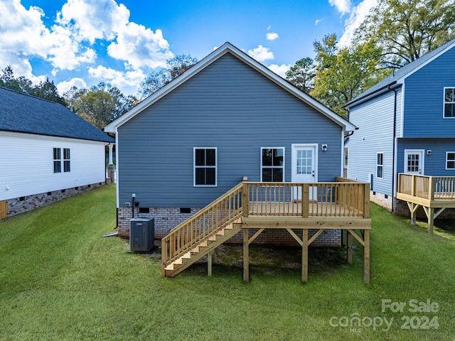 rear view of house with a wooden deck, a yard, central AC, and stairway