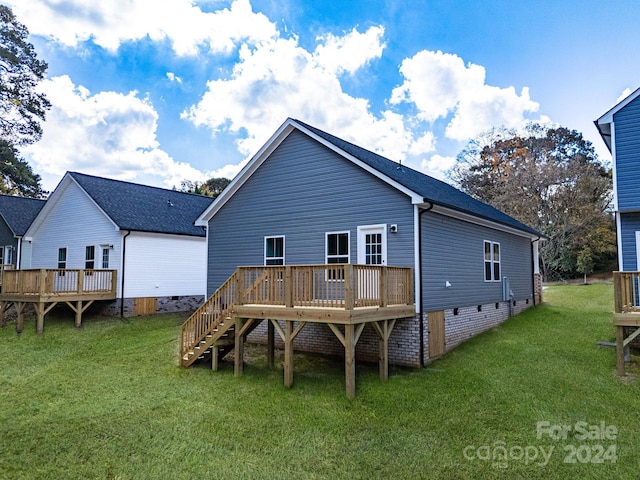 back of property featuring a deck, stairs, a yard, and crawl space