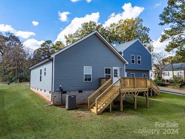back of house featuring stairs, central AC, a wooden deck, and a yard