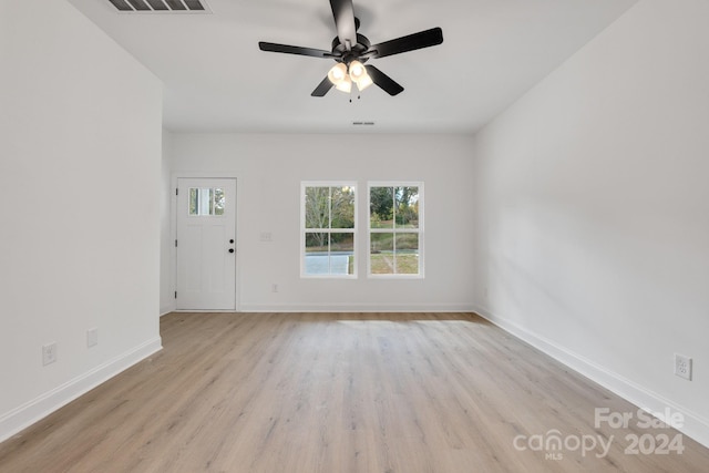 unfurnished living room with a ceiling fan, baseboards, and light wood-style flooring
