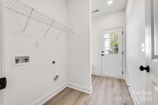 laundry area with light hardwood / wood-style floors, electric dryer hookup, and washer hookup