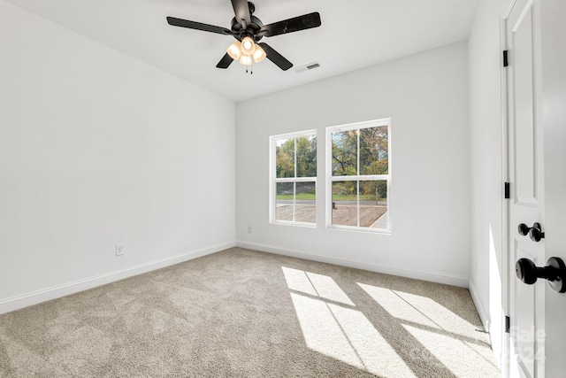 spare room featuring carpet flooring, baseboards, and ceiling fan