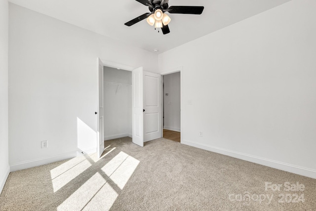 unfurnished bedroom featuring light carpet, a closet, and ceiling fan