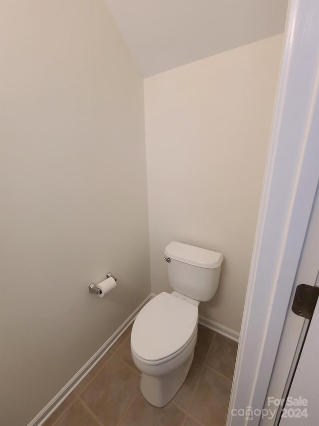 bathroom with toilet and tile patterned floors