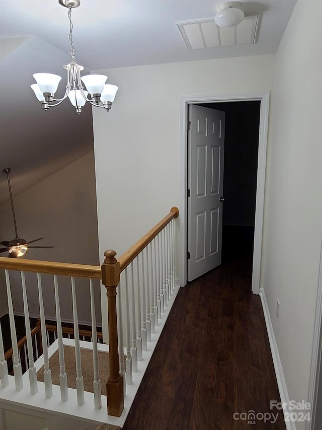 hall with an inviting chandelier and dark hardwood / wood-style flooring