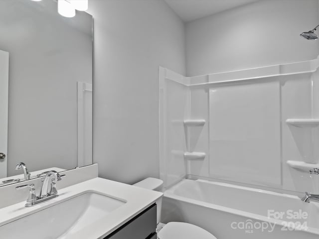 full bathroom with vanity, washtub / shower combination, and toilet