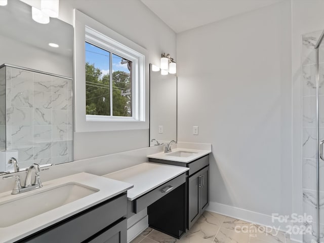 bathroom with vanity and a tile shower