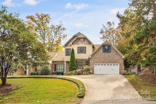 view of front of house featuring a front lawn and a garage