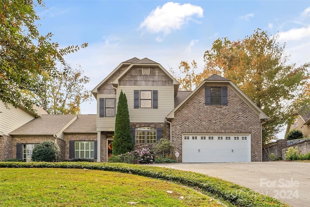 view of front property with a front lawn and a garage