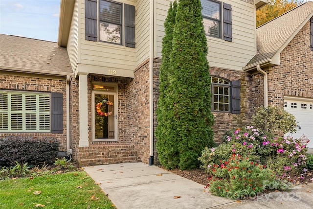 doorway to property with a garage