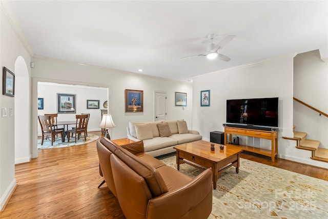 living room with ceiling fan, light hardwood / wood-style flooring, and ornamental molding