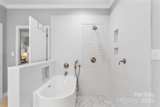 bathroom with ornamental molding and a bathing tub