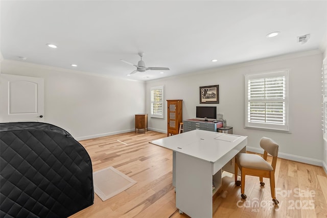 home office with plenty of natural light, light hardwood / wood-style floors, and ornamental molding