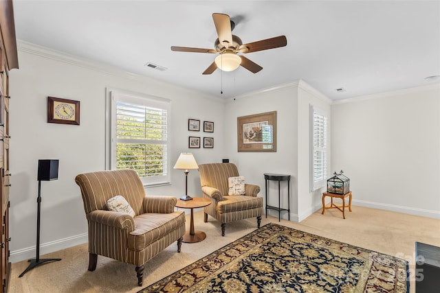 sitting room featuring ceiling fan, light colored carpet, and ornamental molding