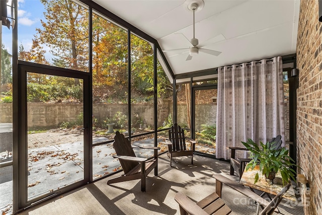 unfurnished sunroom featuring ceiling fan and lofted ceiling