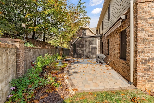 view of patio / terrace featuring a sunroom and area for grilling