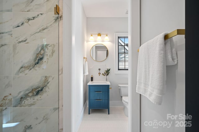 bathroom featuring toilet, walk in shower, and vanity