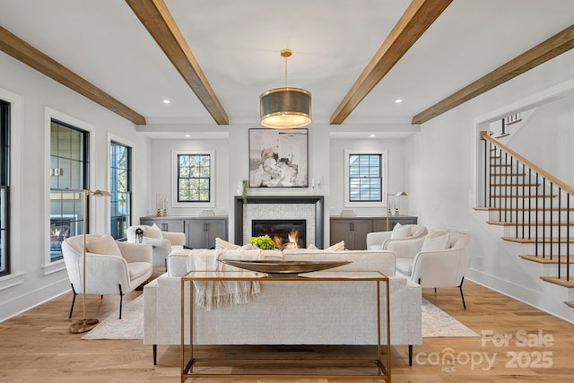 living room with beamed ceiling and light hardwood / wood-style flooring