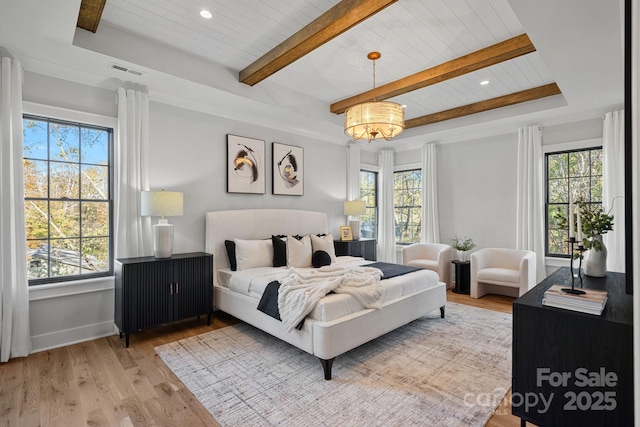 bedroom with wooden ceiling, beam ceiling, a notable chandelier, and light wood-type flooring