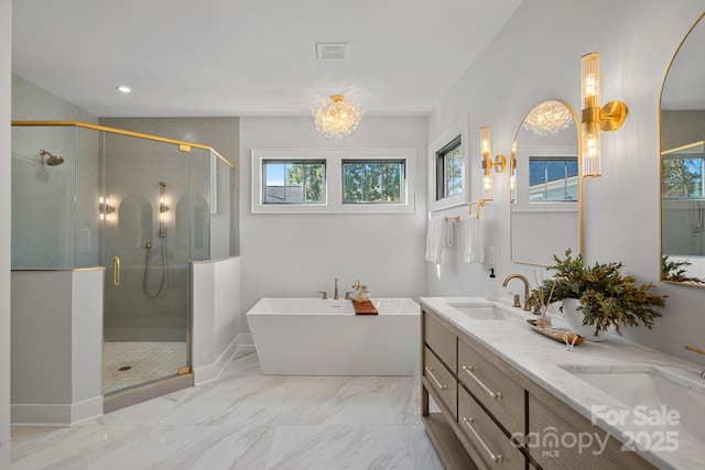 bathroom with a chandelier, shower with separate bathtub, and vanity