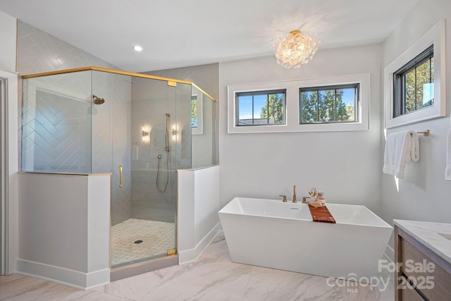 bathroom featuring vanity, a notable chandelier, and independent shower and bath