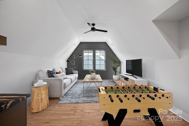 playroom featuring ceiling fan, vaulted ceiling, and light hardwood / wood-style floors