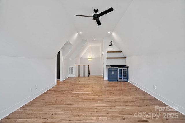 bonus room with light wood-type flooring, ceiling fan, and lofted ceiling