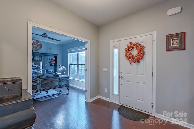 foyer featuring dark wood-type flooring and ceiling fan