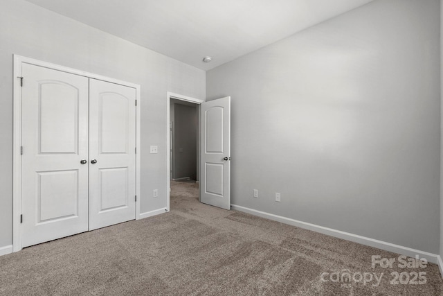 unfurnished bedroom with a closet and carpet floors