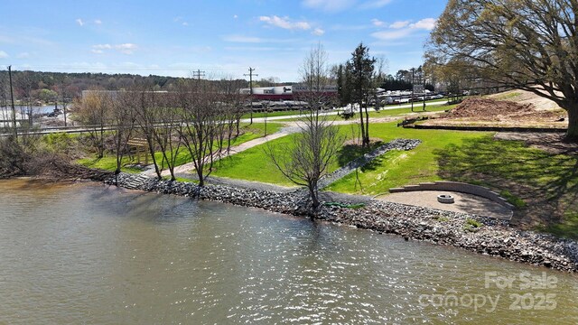 exterior space featuring a water view and a lawn