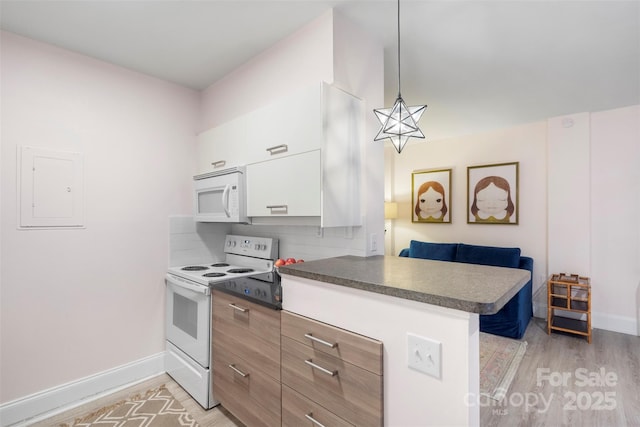 kitchen with electric panel, decorative light fixtures, white appliances, decorative backsplash, and white cabinets