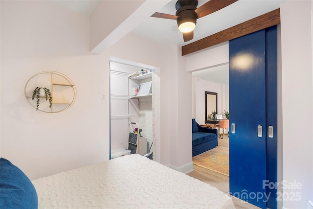 bedroom featuring ceiling fan, wood-type flooring, and a closet