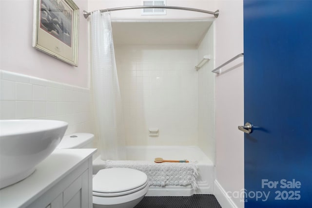 full bathroom featuring vanity, shower / bathtub combination with curtain, tile walls, and toilet