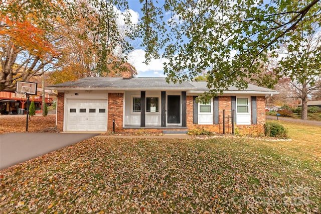 ranch-style home featuring a front lawn and a garage