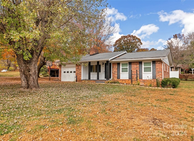 single story home featuring covered porch, a front lawn, and a garage